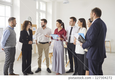 Business people group professional achievement, offering support, standing talking in modern office 127304272