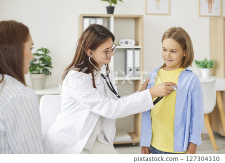 Pediatrician woman examination, stethoscope listening to heart, lungs, female medical practitioner Pediatrician woman examination, stethoscope listening to heart, lungs, female medical practitioner 127304310