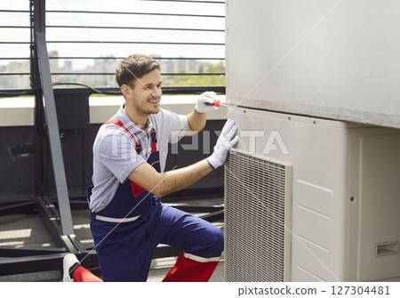 Electrician Installing, Servicing, Or Repairing Hvac System On Roof 127304481