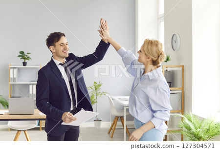 Business People Celebrating Success And Agreement In The Office Business People Celebrating Success And Agreement In The Office 127304571