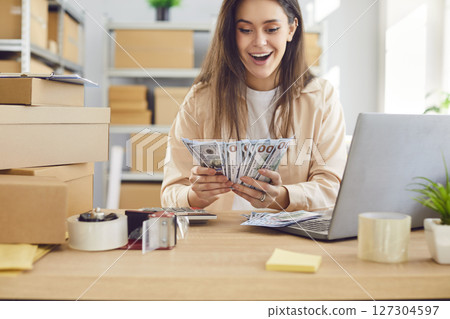 Businesswoman Working In Warehouse, Celebrating Profit And Holding Cash 127304597