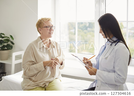 Senior woman patient visiting a doctor at the medical office during medical examination. 127304616