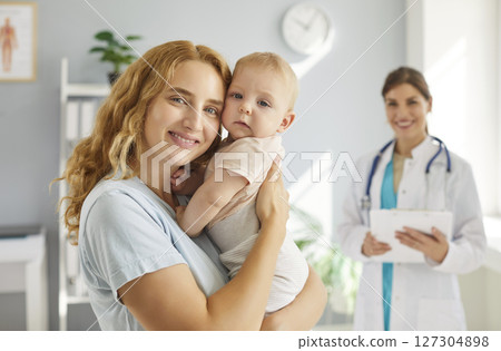 Portrait of a happy healthy young mother and her little baby at a pediatric clinic 127304898