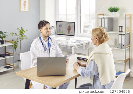 Doctor Or Nurse Consulting With Patient In Hospital Office Doctor Or Nurse Consulting With Patient In Hospital Office 127304936