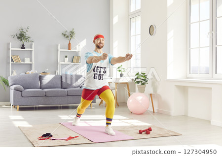 Cheerful man in eccentric sportswear doing aerobics at home Cheerful man in eccentric sportswear doing aerobics at home 127304950