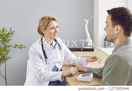 Doctor Or Nurse Consults Patient In Hospital Office Doctor Or Nurse Consults Patient In Hospital Office 127305044