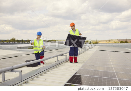Workers Installing And Maintaining Solar Panels On Roof For Renewable Energy Workers Installing And Maintaining Solar Panels On Roof For Renewable Energy 127305047