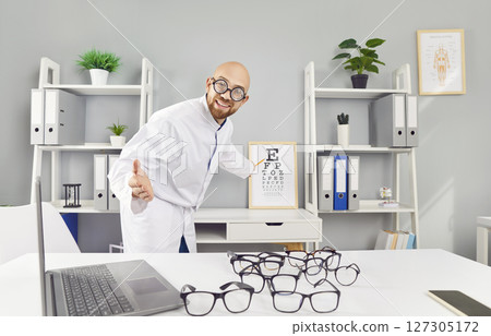 Optician with large round glasses invites you to check your vision using special table with letters. Optician with large round glasses invites you to check your vision using special table with letters. 127305172