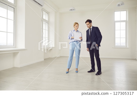 Woman Realtor Showing New Home Or Office To Business Client Woman Realtor Showing New Home Or Office To Business Client 127305317