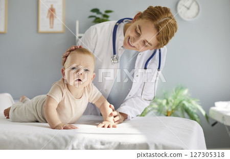 Pediatrician Examines Young Child Patient In Hospital Setting 127305318