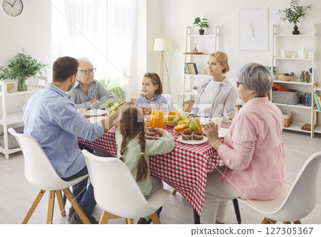 Large Happy Family Enjoying Holiday Dinner Together At Home 127305367