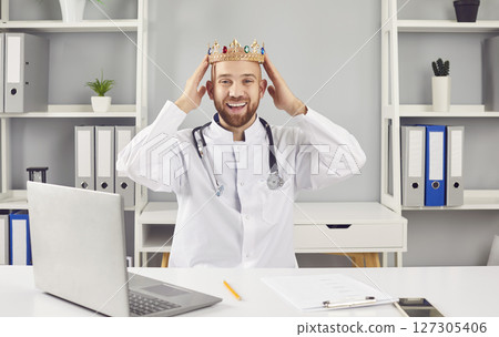 Happy Smiling Doctor Or Nurse Wearing King Crown In Hospital Happy Smiling Doctor Or Nurse Wearing King Crown In Hospital 127305406