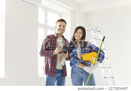 Happy Couple Painting Walls During Home Renovation 127305407