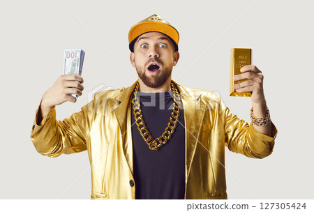 Surprised Man Holding Money And Gold Bar 127305424