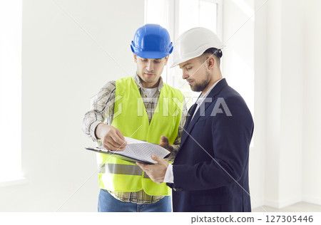 Builder And Businessman Planning Construction Or Renovation Builder And Businessman Planning Construction Or Renovation 127305446