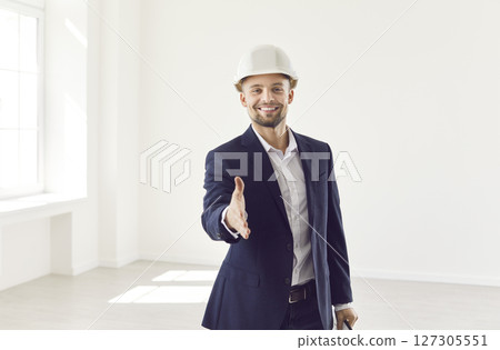 Portrait Of Happy Businessman Offering Handshake During Renovation Portrait Of Happy Businessman Offering Handshake During Renovation 127305551