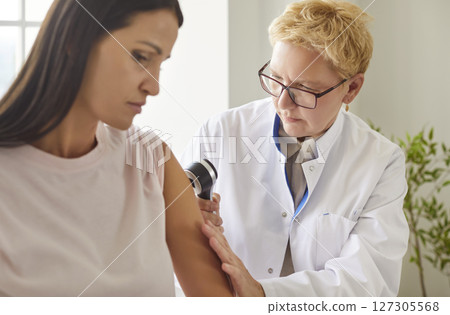 Doctor Administering Vaccination To Patient At Hospital 127305568