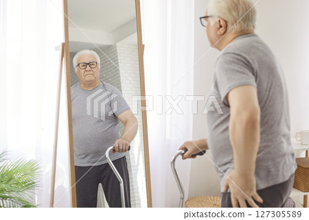 Senior old man, pleasant elderly person retired patient looking in mirror seeing his body at home Senior old man, pleasant elderly person retired patient looking in mirror seeing his body at home 127305589
