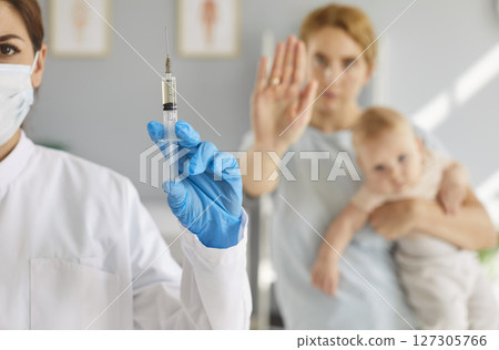 Anti-vaccine activism, mother proclaiming opposition to vaccination for newborn baby, stop  Anti-vaccine activism, mother proclaiming opposition to vaccination for newborn baby, stop  127305766