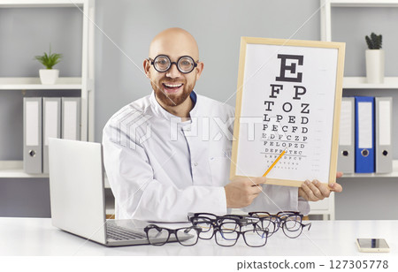 Funny Ophthalmologist Conducting Vision Checkup With Chart In Hospital 127305778