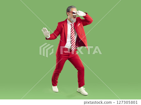 Full length shot of carefree happy showman or show presenter dressed in elegant red suit dancing 127305801