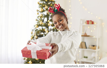 Portrait Of African American Woman With A Gift Box During Christmas Or New Year Portrait Of African American Woman With A Gift Box During Christmas Or New Year 127305868