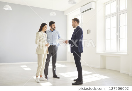 Real Estate Agent Showing New Home To Couple 127306002