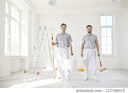 Smiling successful male painters or construction workers, professional service team standing  127306015