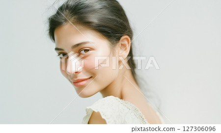 Close-up of a smiling Southeast Asian woman's profile on white background Close-up of a smiling Southeast Asian woman's profile on white background 127306096