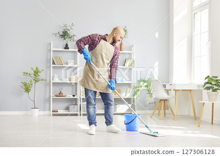 Happy Man Cleaning House And Mopping Floors With A Smile Happy Man Cleaning House And Mopping Floors With A Smile 127306128