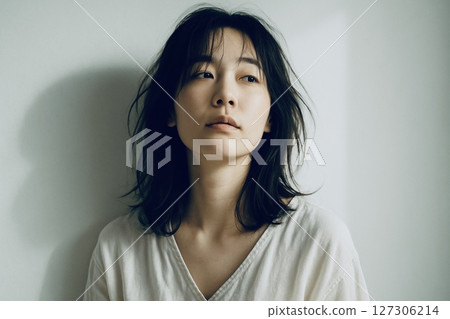 Portrait of a pensive woman in soft natural light 127306214