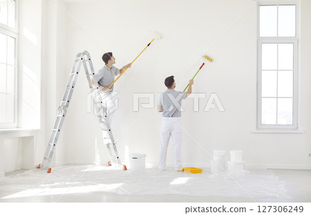 Team Of Man Painters Painting Wall During Home Or Office Renovation 127306249