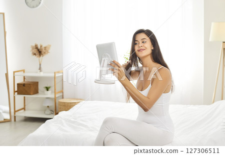 Morning home care, beautiful female looking in mirror doing beauty procedures, combing hair Morning home care, beautiful female looking in mirror doing beauty procedures, combing hair 127306511