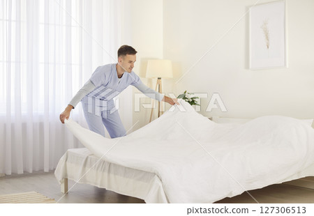 Doctor Or Caregiver Making Bed At Nursing Home Or Hospital 127306513