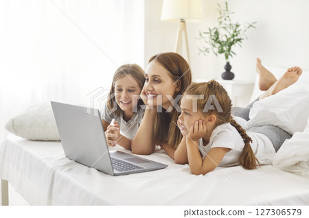 Happy family laptop watching, online mother on weekend morning, kid girl, boy, loving mum 127306579
