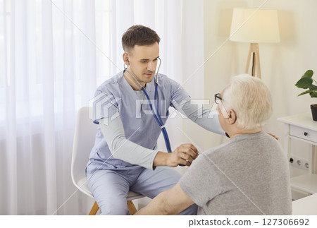 Doctor Or Nurse Examining Senior Patient's Lungs With Stethoscope In Hospital Doctor Or Nurse Examining Senior Patient's Lungs With Stethoscope In Hospital 127306692