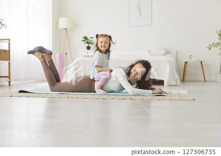 Happy active playful funny family game, mother parent, babysitter, small child daughter together 127306735