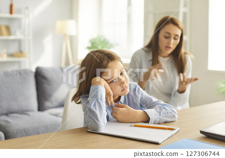 Sad tired teenage boy unwilling to study at home, worried parent mom persuading helping comforting 127306744