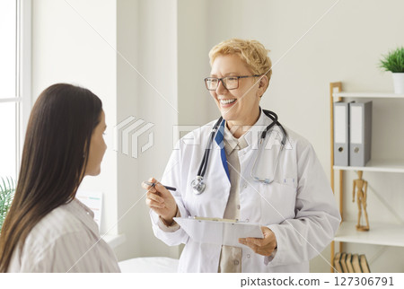 Elderly Doctor Or Nurse Consulting A Patient In A Hospital Elderly Doctor Or Nurse Consulting A Patient In A Hospital 127306791