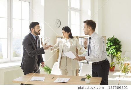 Angry Business Team Arguing And Shouting During Office Meeting 127306801