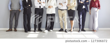 Diverse Business Team Standing On Grey Background In Office Diverse Business Team Standing On Grey Background In Office 127306872