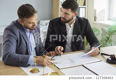 Lawyers at desk consulting, discussing to advise and represent client in criminal, civil proceeding 127306883