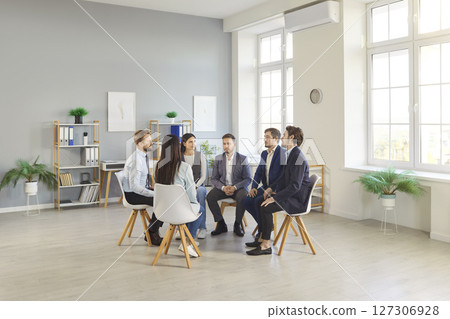 Diverse Group Of Colleagues Meeting And Talking In A Circle At The Office Diverse Group Of Colleagues Meeting And Talking In A Circle At The Office 127306928