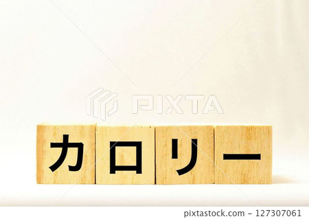 A building block with the word "calories" written on it 127307061