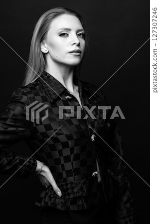 Beautiful woman with checkered suit black and white studio portrait 127307246