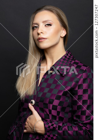 Beautiful woman with checkered suit studio portrait 127307247