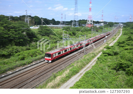 The Keikyu 1000 series express train bound for Narita Airport speeding along the Narita Sky Access Line 127307293