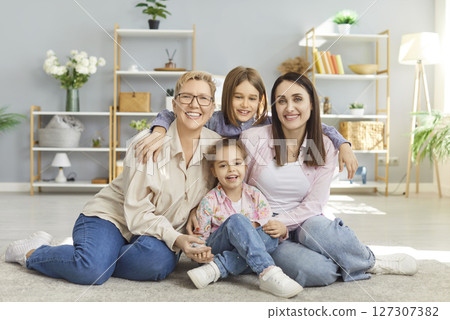 Happy family together, grandchildren, mother and grandmother friendly portrait at home, sit laughing 127307382