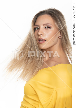 Beautiful woman with yellow dress studio portrait in white background Beautiful woman with yellow dress studio portrait in white background 127307449