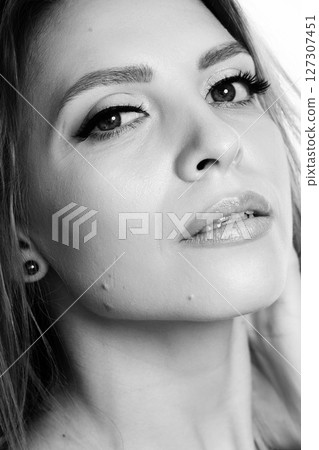 Beautiful young woman with classic make-up black and white studio portrait 127307451